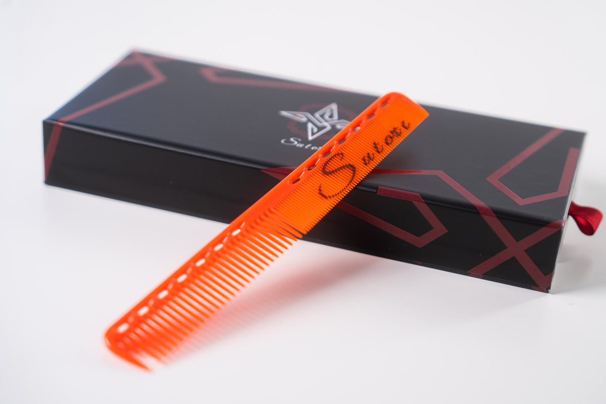 Orange Sutori cutting comb resting on the box