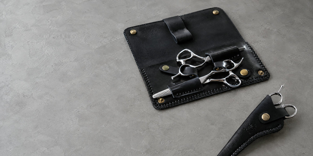 Double leather case and blade protector on grey microcement