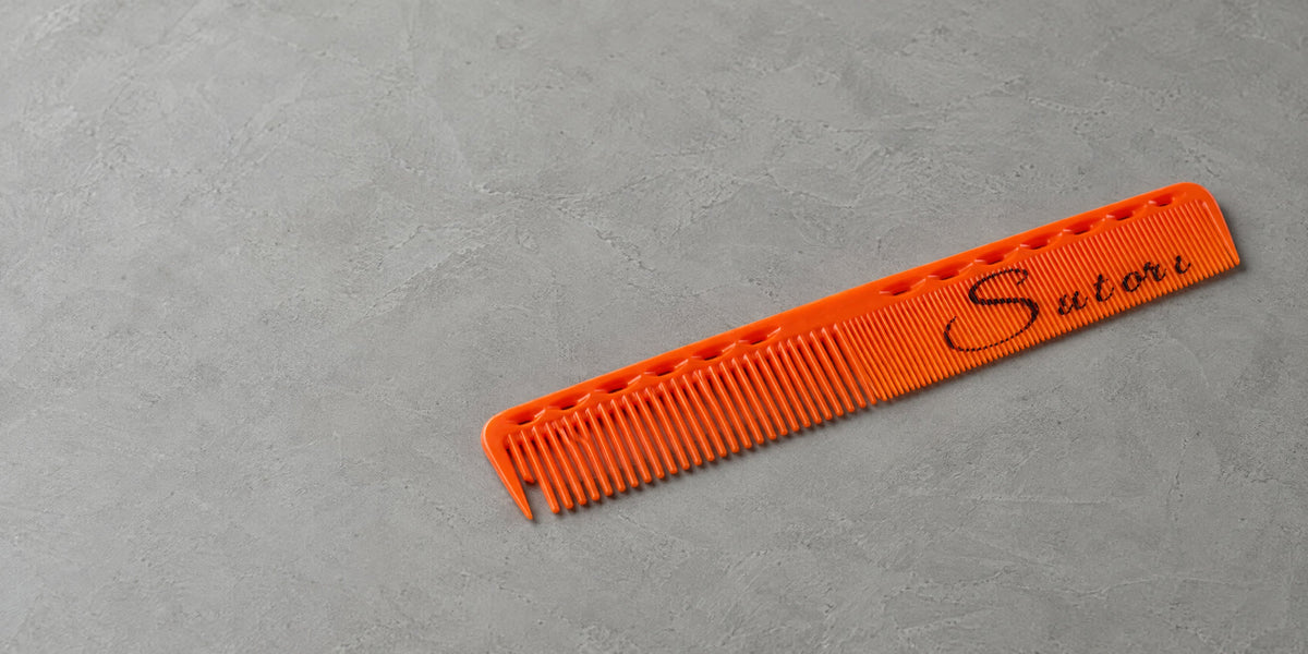 Orange Sutori cutting comb on grey microcement