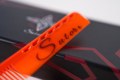 Sutori logo on the orange cutting comb, close up 